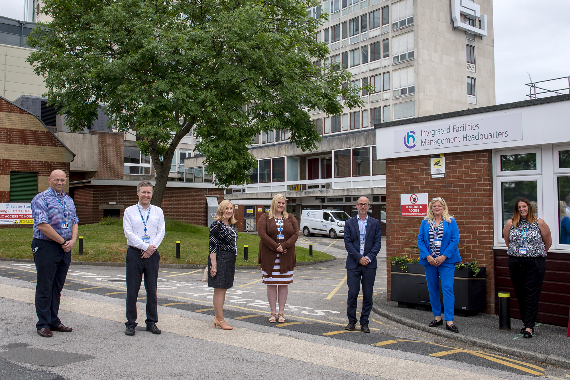 Multiple members of staff stood outside the CHS office.