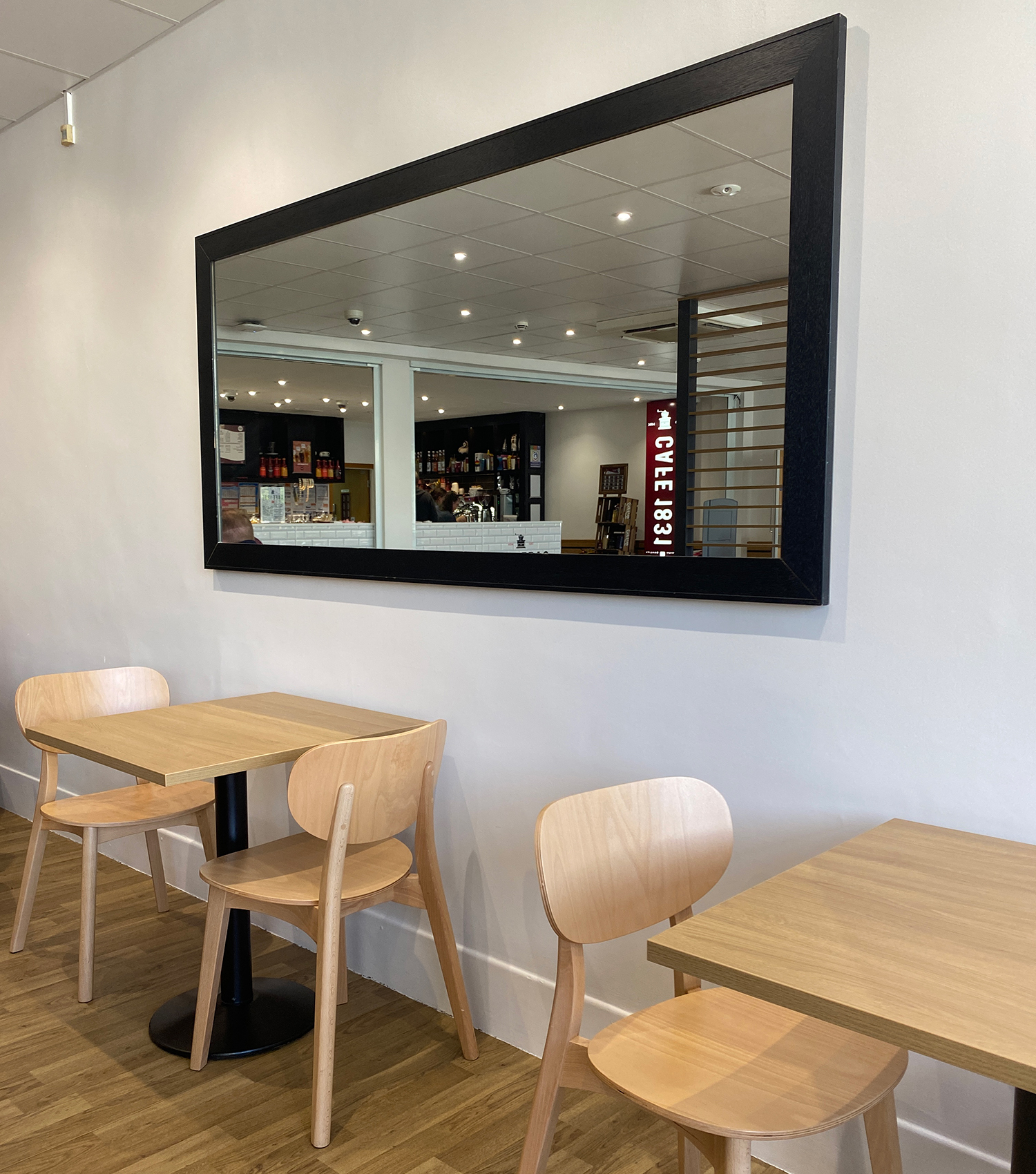 Cafe 1831 seating area with a mirror on the wall