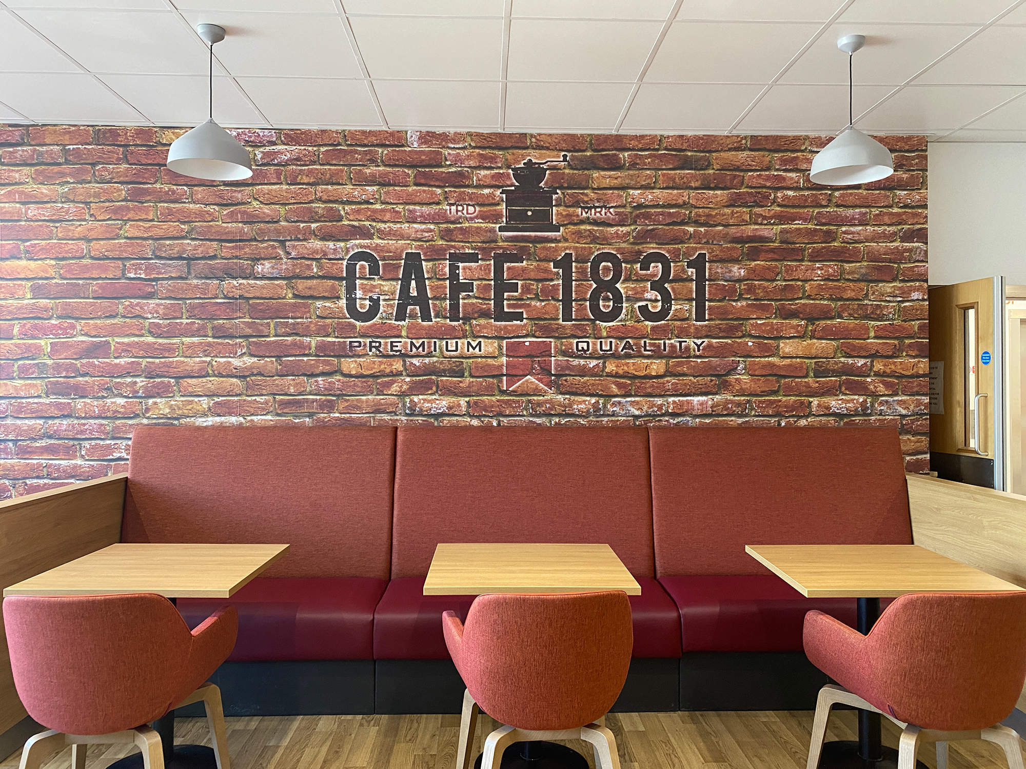 Cafe 1831 seating area with Cafe 1831 Premium Quality on the wall