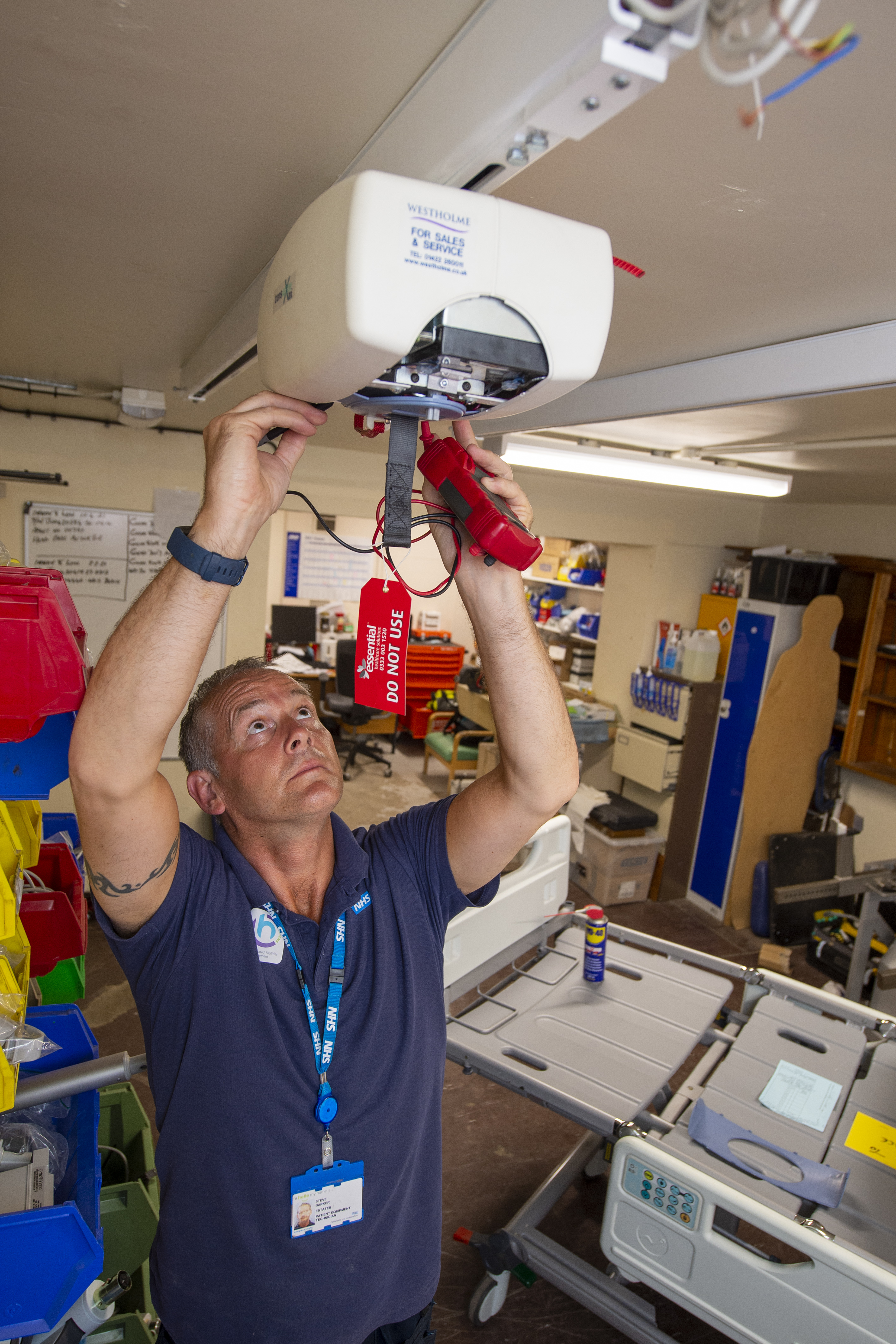 Male staff member fixing equipment.